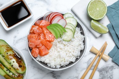 Photo of Delicious poke bowl with salmon and vegetables served on white marble table, flat lay