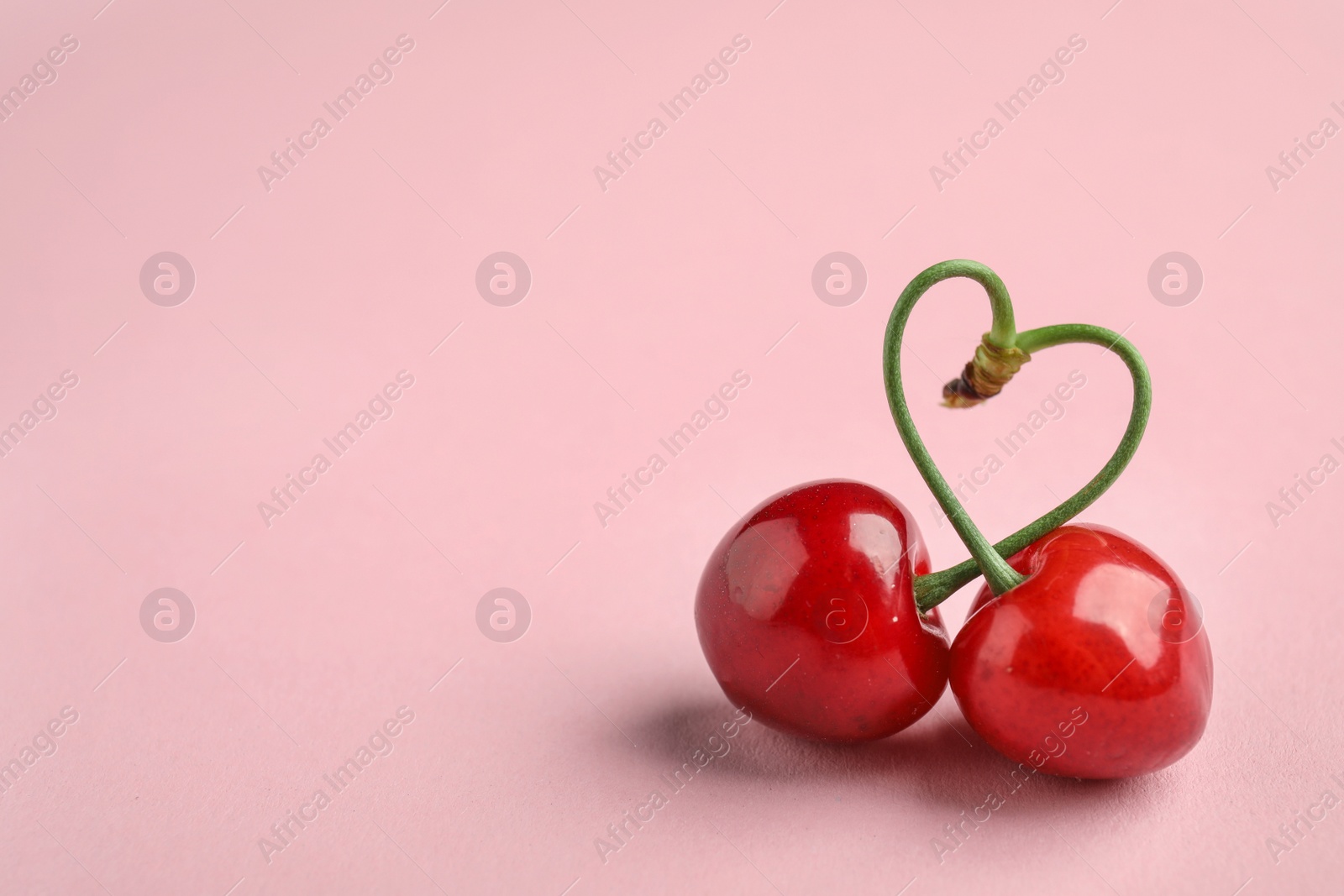 Photo of Sweet red cherries on color background