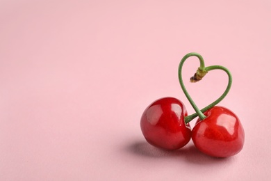 Photo of Sweet red cherries on color background