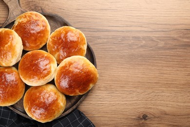 Photo of Freshly baked soda water scones on wooden table, top view and space for text