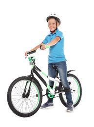 Portrait of cute little boy with bicycle on white background