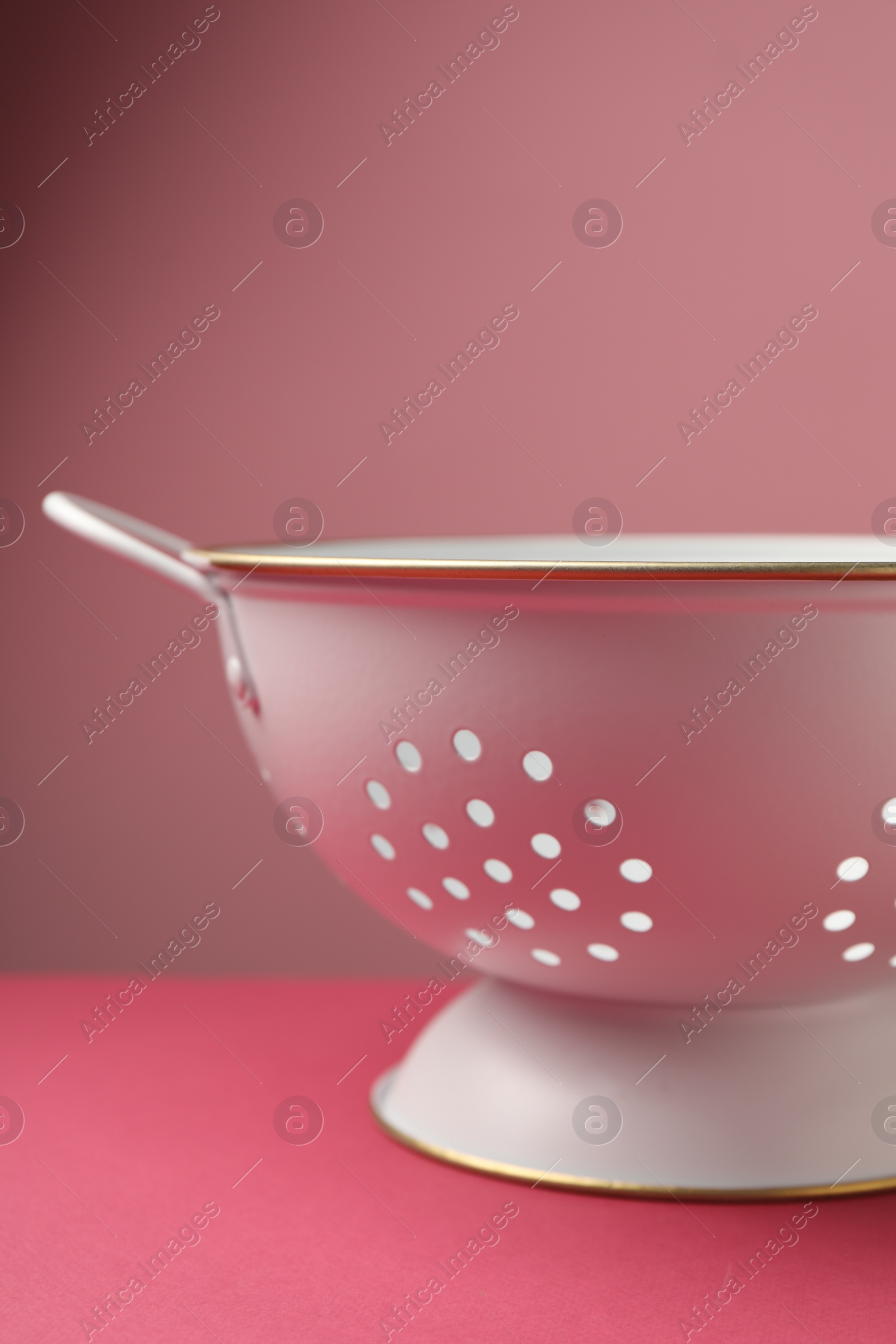 Photo of One clean empty colander on color background, closeup