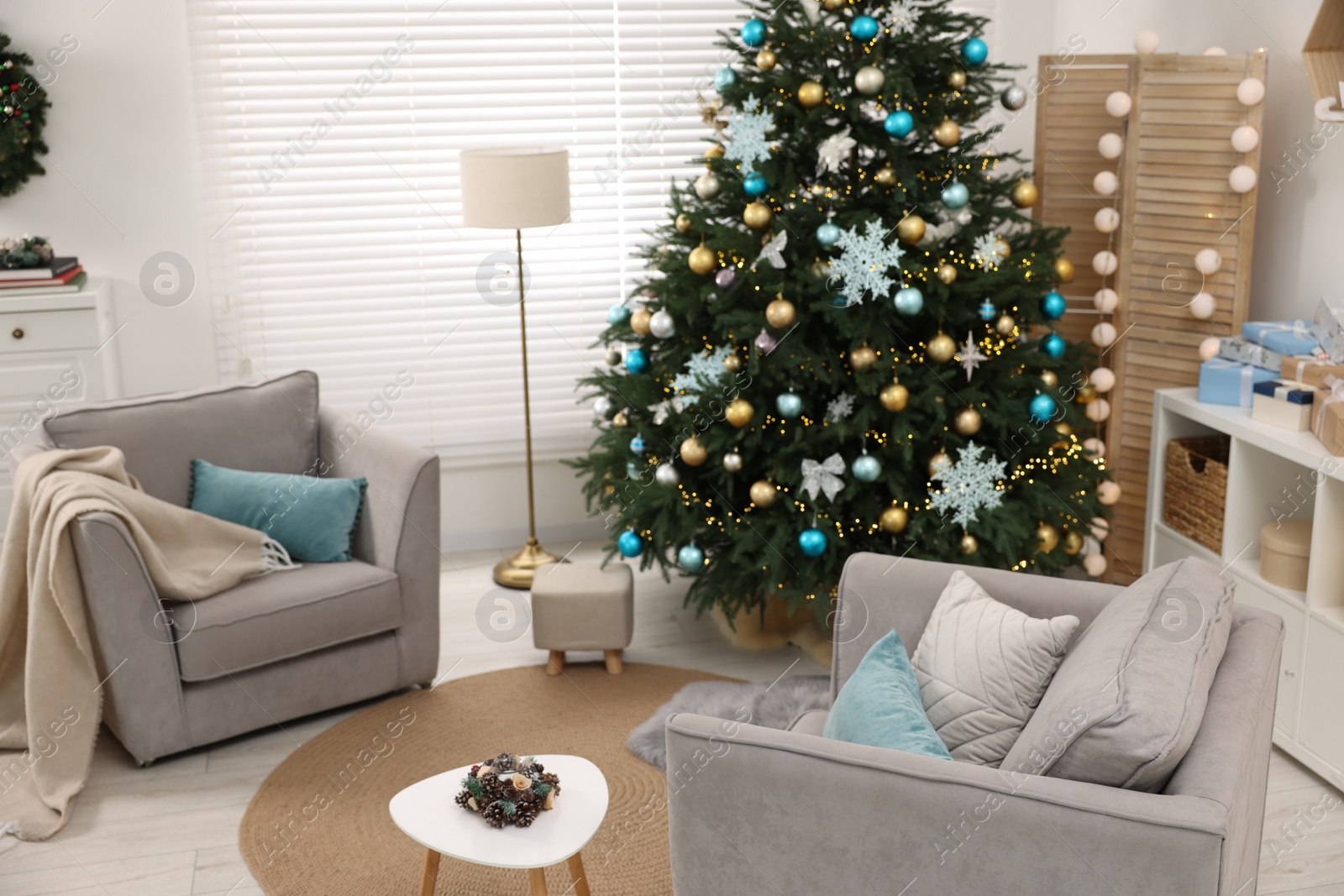 Photo of Christmas tree in room decorated for holiday. Festive interior design