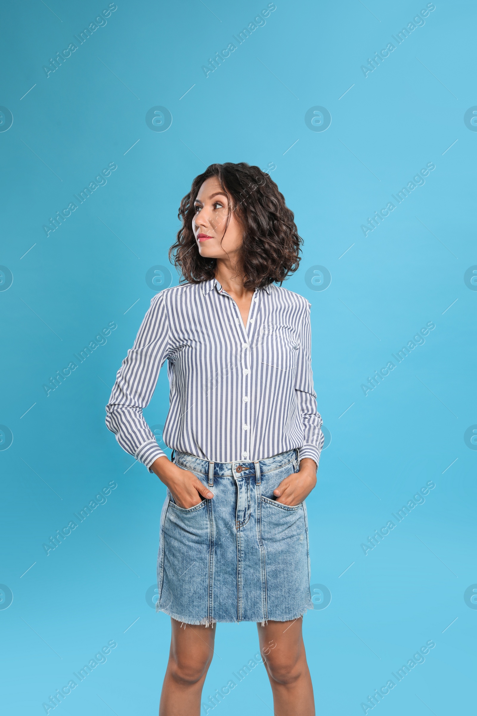 Photo of Happy young woman in casual outfit on blue background