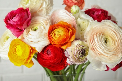 Beautiful spring ranunculus flowers in vase on blurred background, closeup