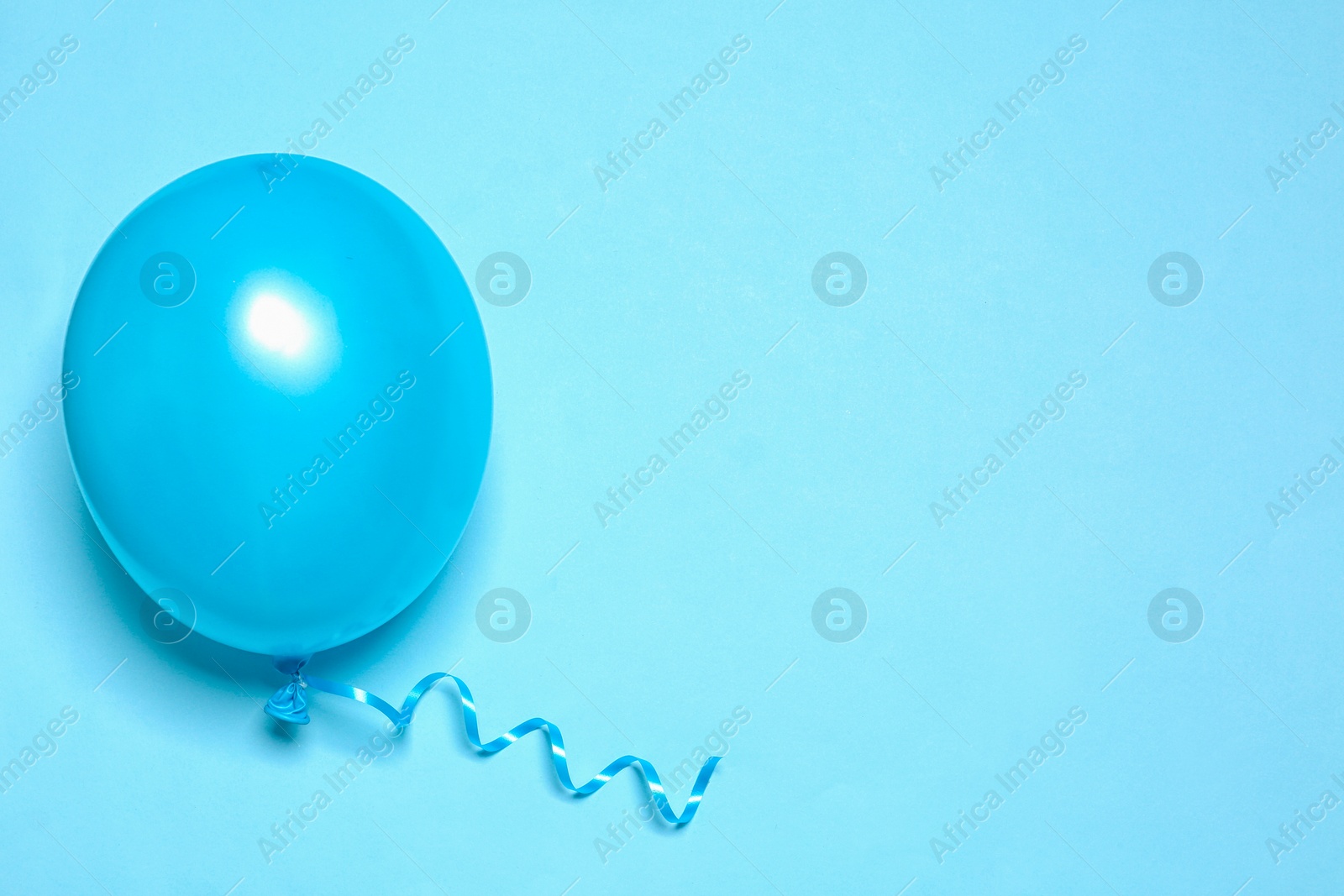 Photo of Bright balloon on color background, top view with space for text. Party time