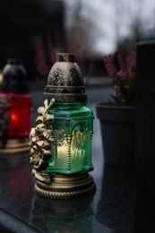 Photo of Grave lights on granite surface at cemetery