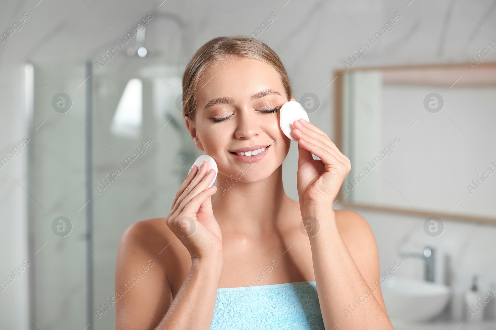 Photo of Beautiful young woman with cotton pads indoors