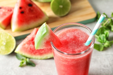 Photo of Tasty summer watermelon drink in glass on table, closeup