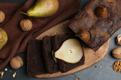 Photo of Flat lay composition with tasty pear bread on black table. Homemade cake