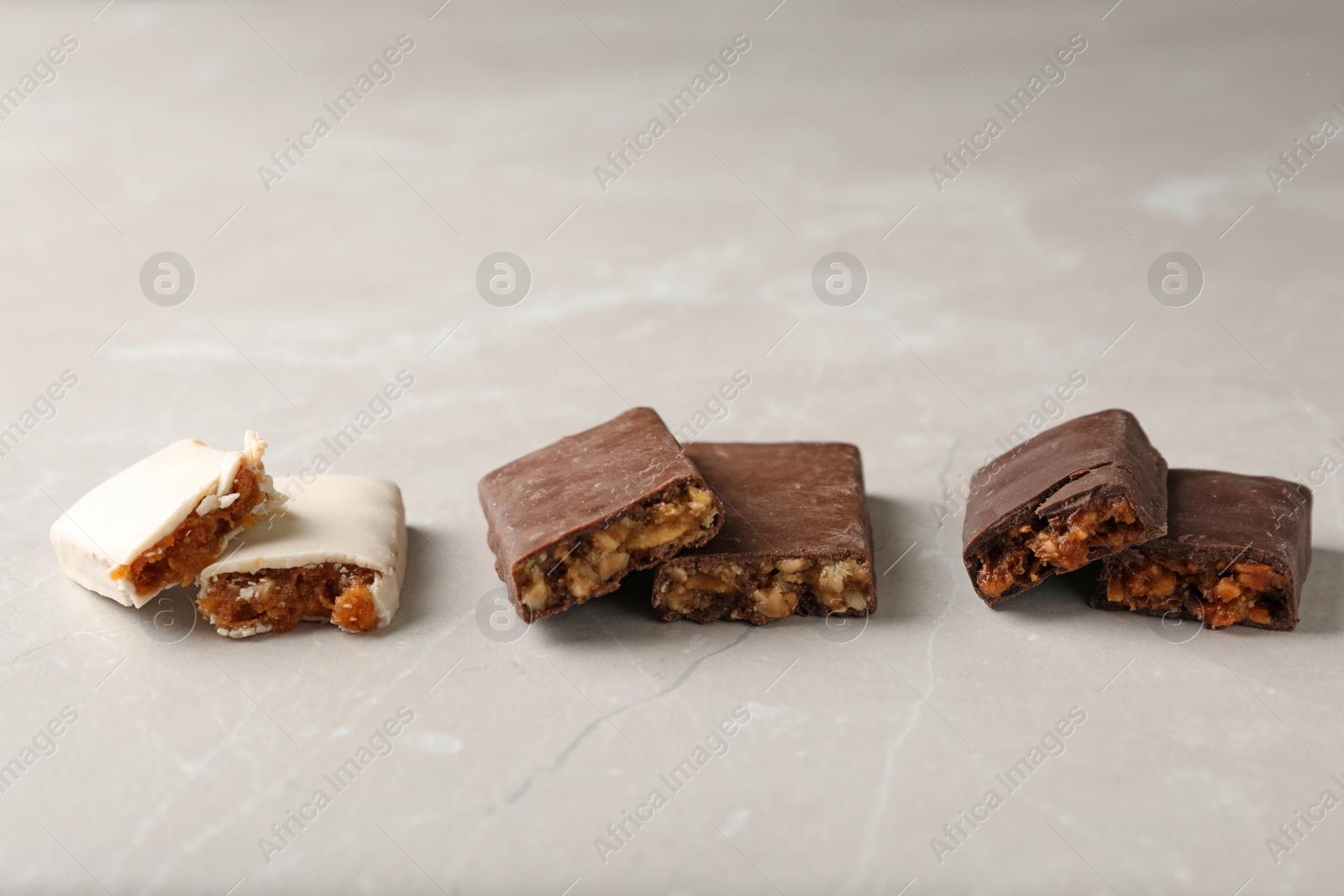 Photo of Tasty protein bars on grey table. Healthy snack