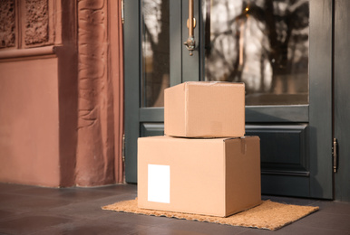 Photo of Delivered parcels on door mat near entrance