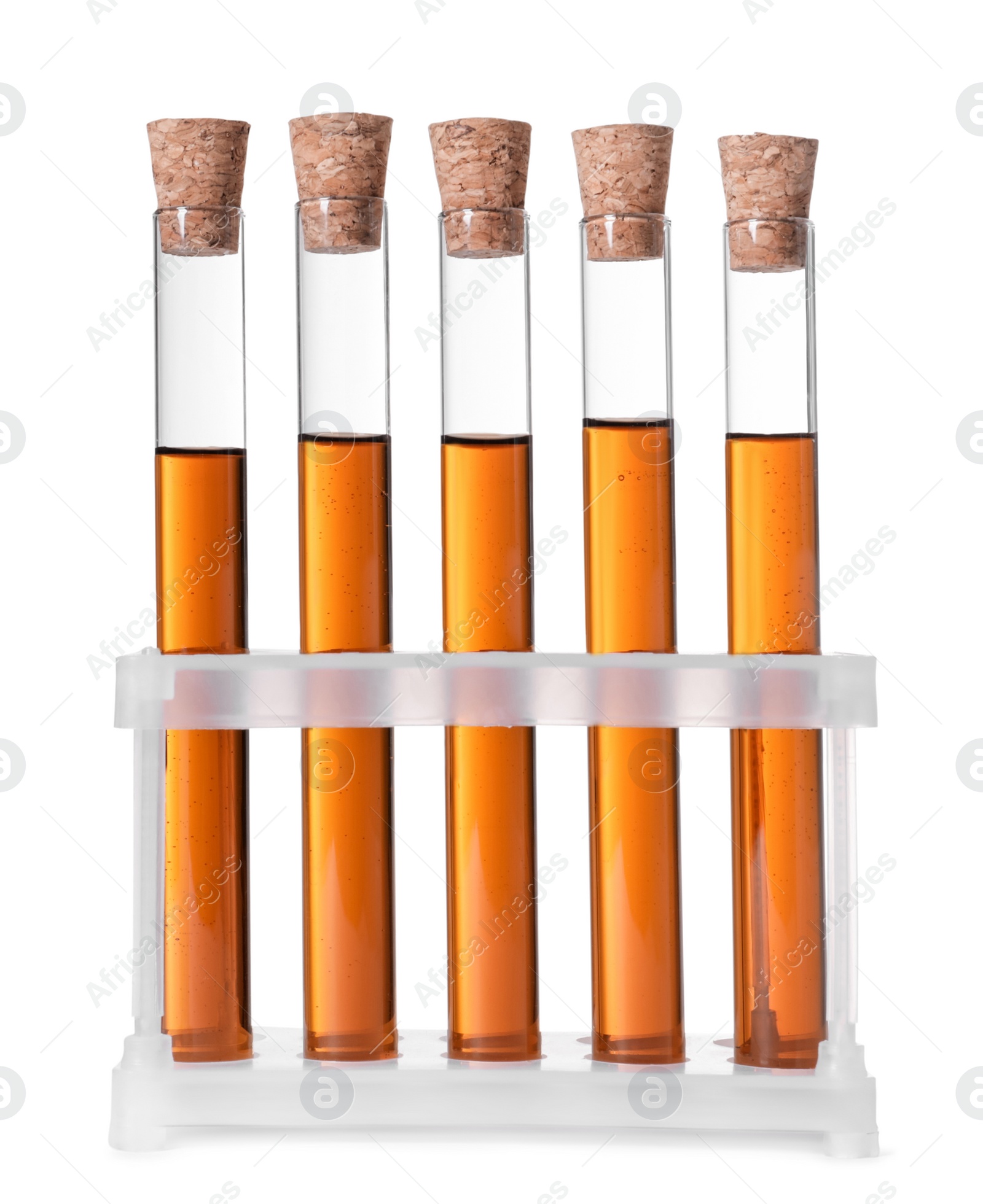 Photo of Test tubes with brown liquid in stand on white background