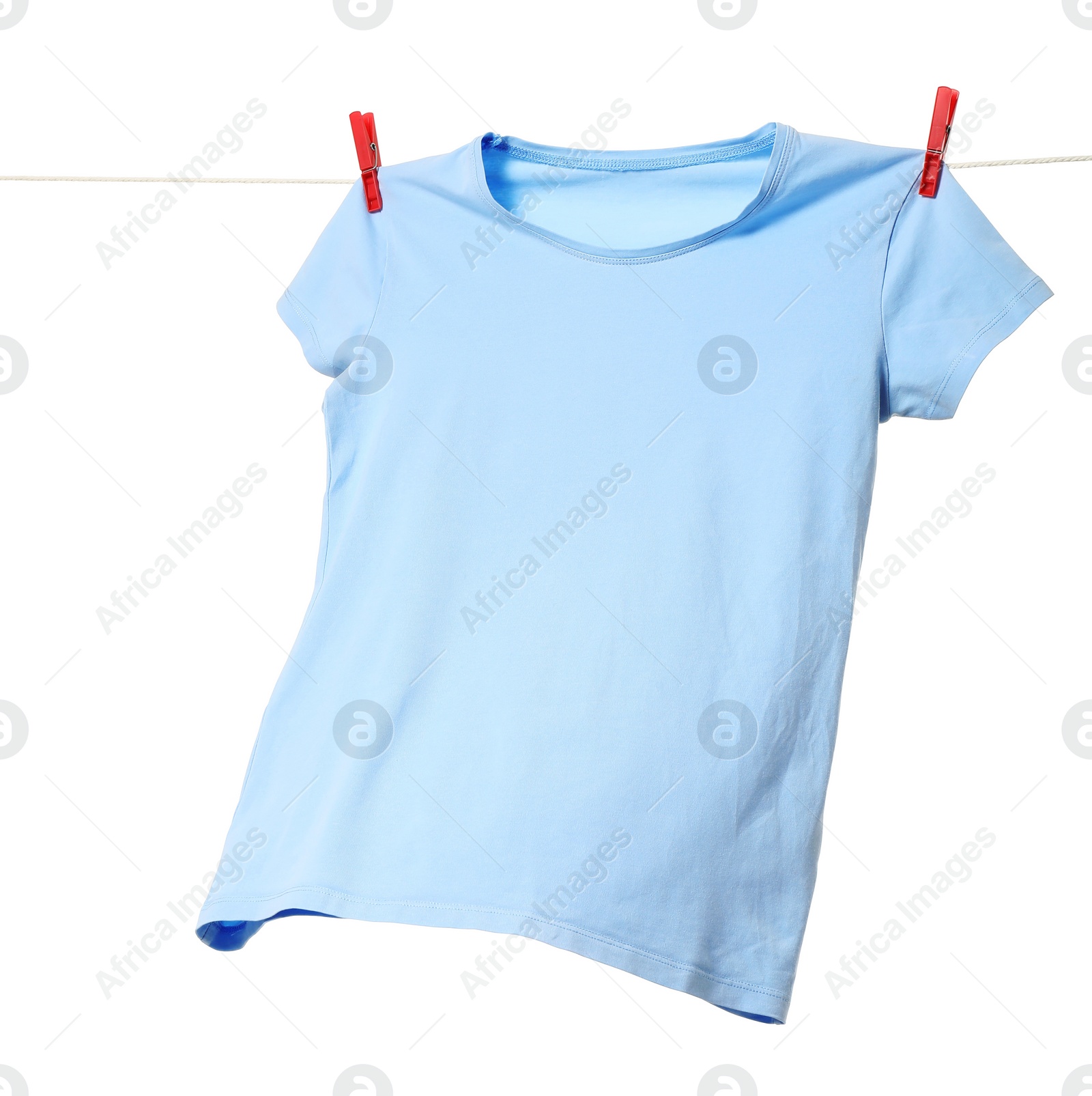 Photo of One light blue t-shirt drying on washing line isolated on white