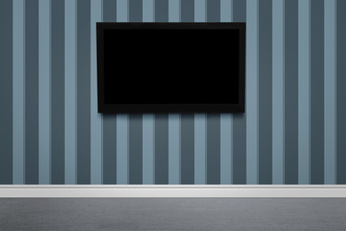 Image of Modern TV on color wall in room. Space for design