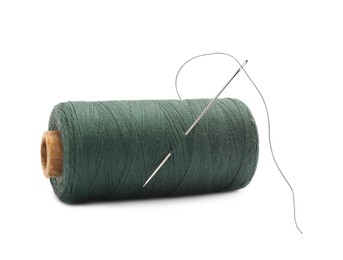 Green sewing thread with needle on white background