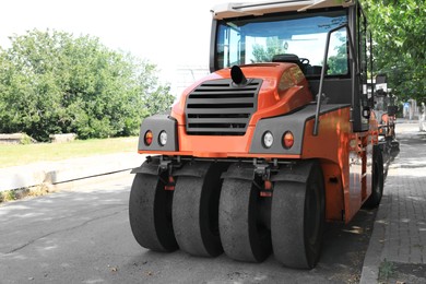 Photo of Modern roller on city street. Road repair service