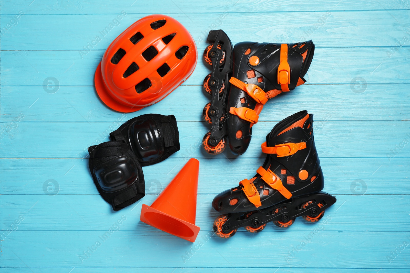 Photo of Flat lay composition with inline roller skates on wooden background