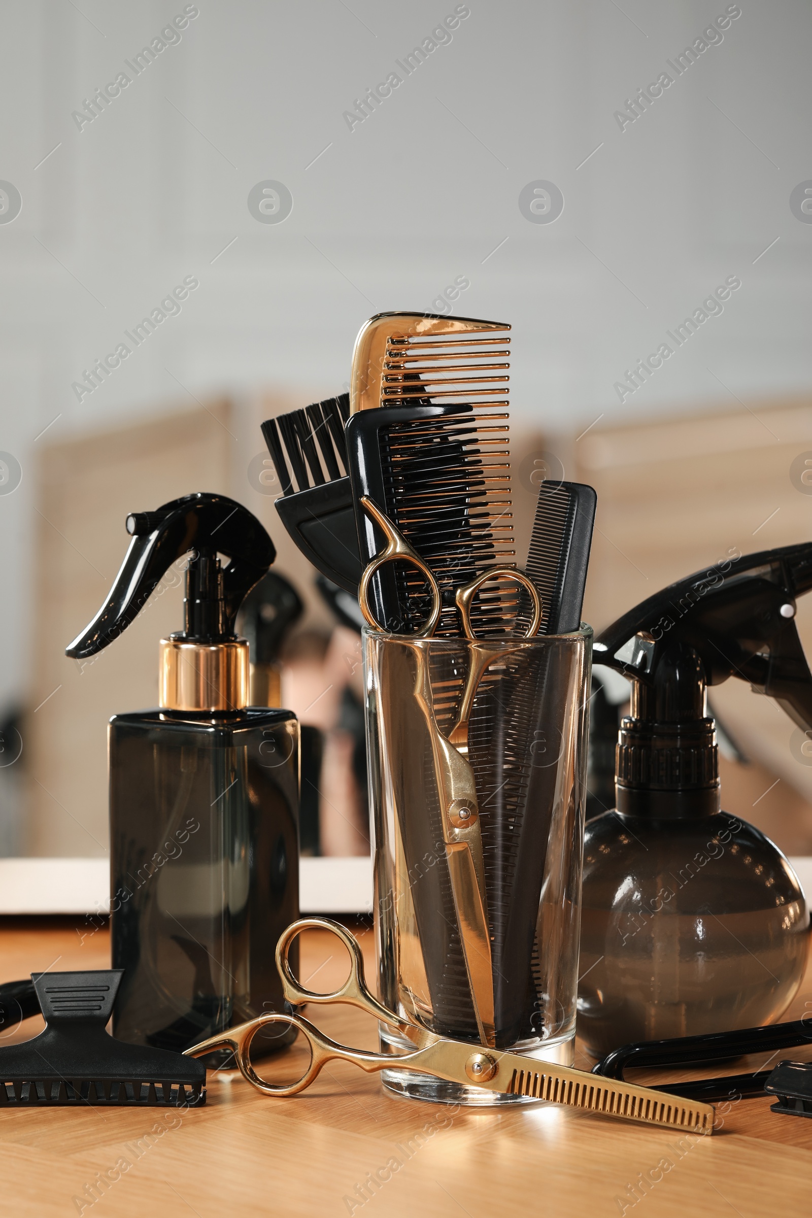 Photo of Set of hairdresser tools on table in salon