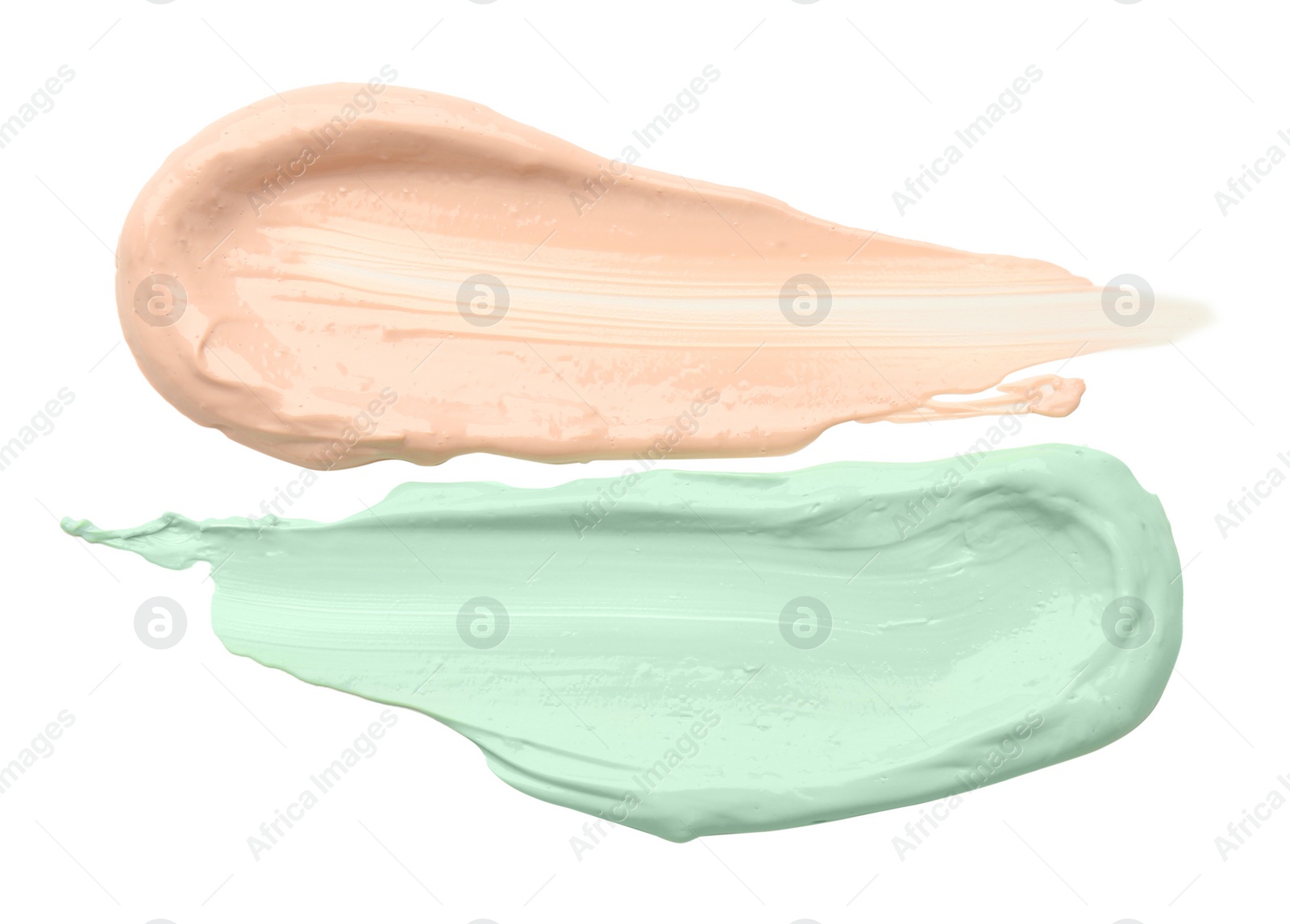 Photo of Strokes of pink and green color correcting concealers isolated on white, top view