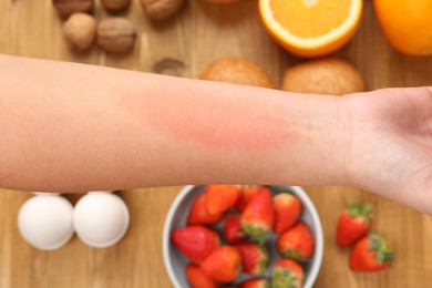 Photo of Food allergy. Woman holding hand over products on table, closeup