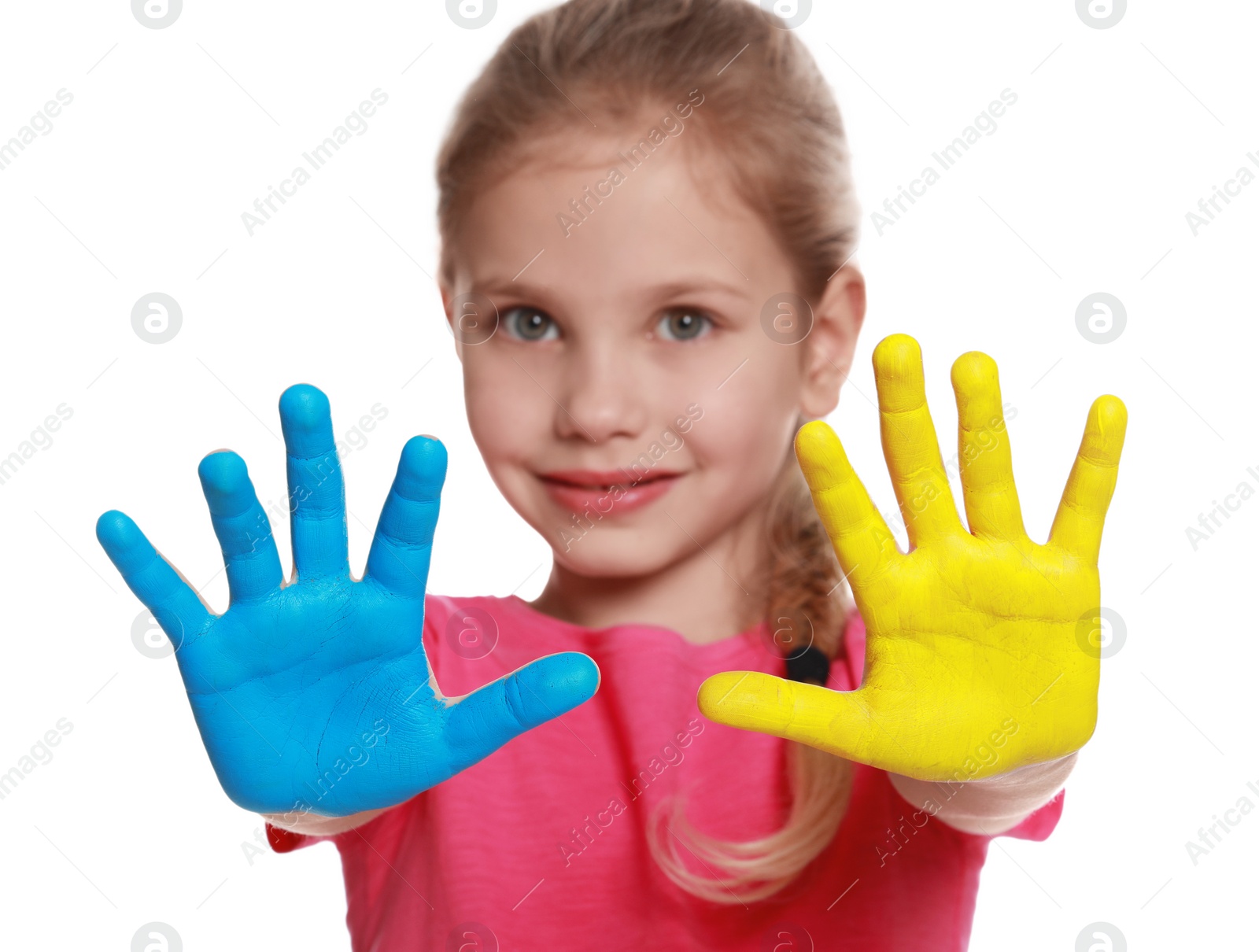 Photo of Little girl with hands painted in Ukrainian flag colors against white background, focus on palms. Love Ukraine concept