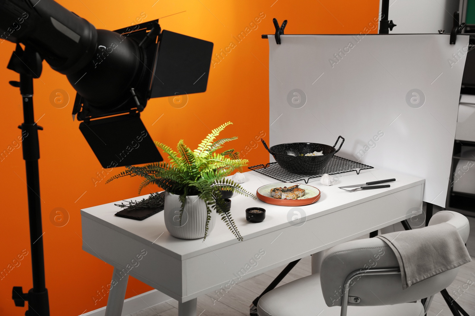 Photo of Professional equipment and composition with delicious meat medallion on white table in studio. Food photography