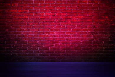 Image of Room with brick wall and wooden floor in neon lights