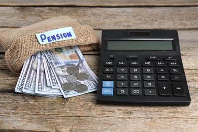 Photo of Bag with money, word Pension and calculator on wooden table. Retirement concept