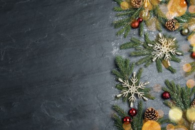 Photo of Flat lay composition with fir branches and Christmas decor on black background, space for text. Greeting card design