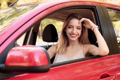 Photo of Happy young beautiful woman driving modern car