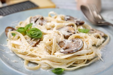 Delicious pasta with mushrooms and cheese on plate, closeup