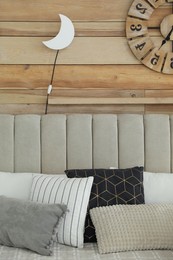 Photo of Crescent shaped night lamp on wooden wall in room