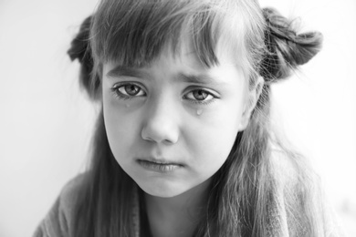 Photo of Portrait of sad little girl, black and white effect