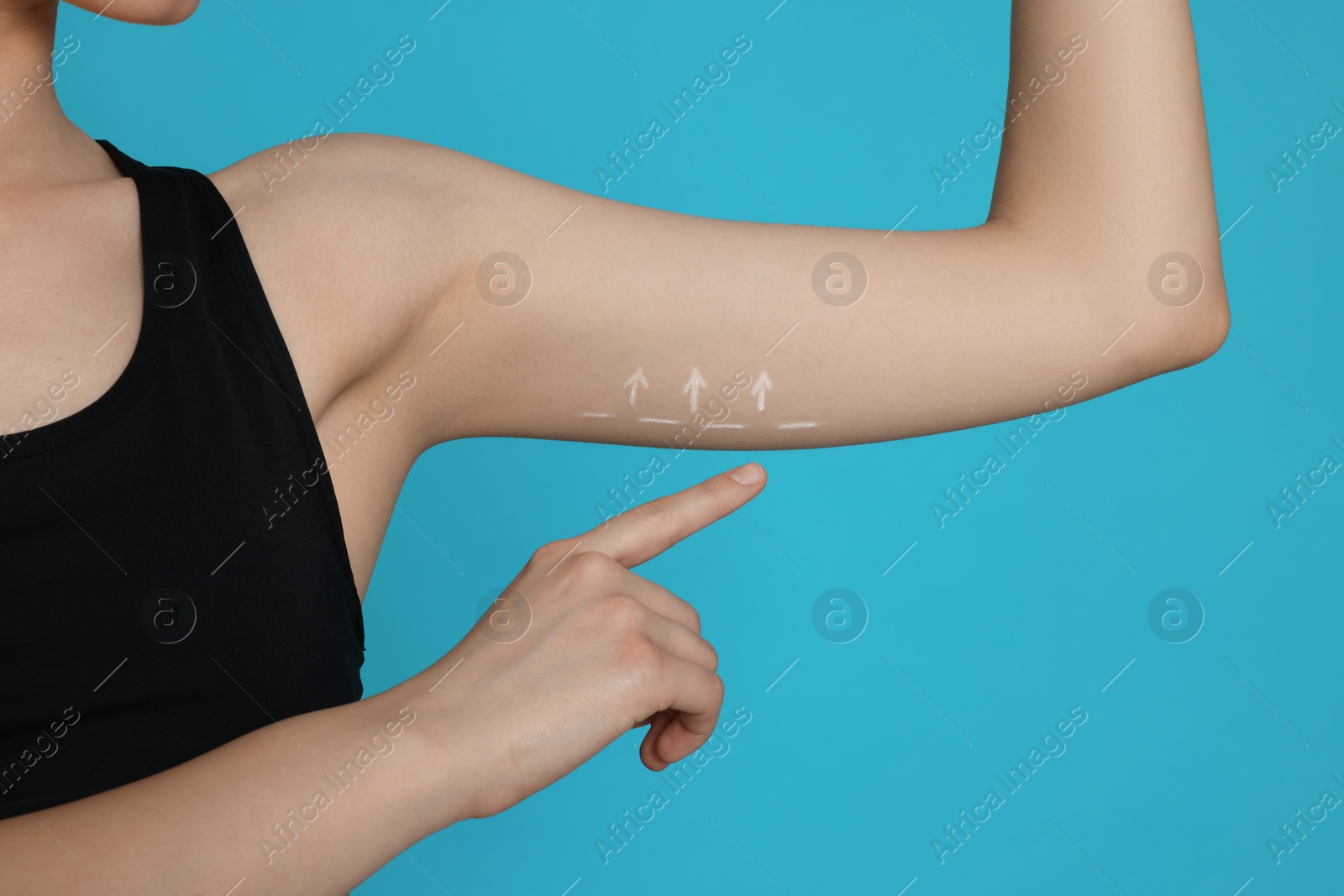 Photo of Slim woman with thin arm on light blue background, closeup. Weight loss surgery