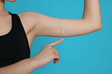 Photo of Slim woman with thin arm on light blue background, closeup. Weight loss surgery