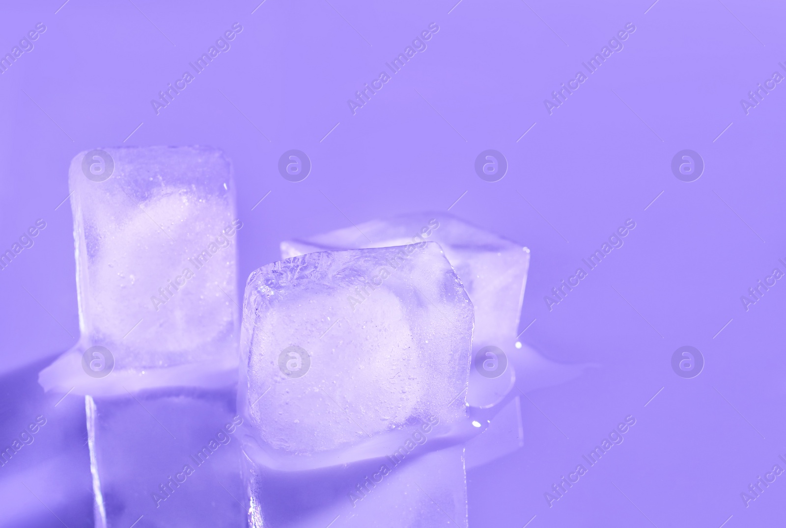 Photo of Ice cubes on color background. Space for text