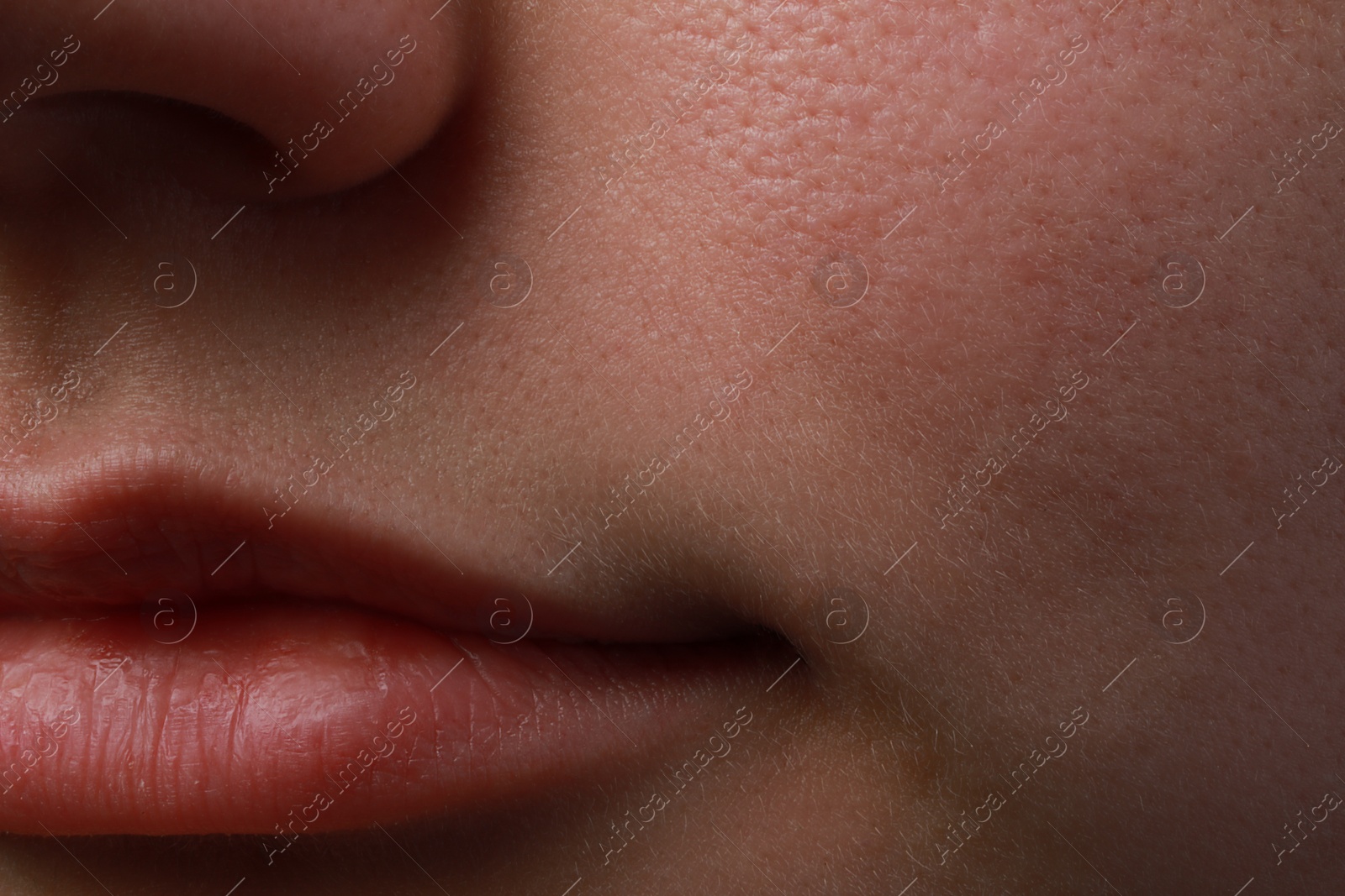 Photo of Closeup view of woman with normal skin and beautiful lips