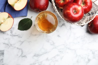 Flat lay composition with delicious apple cider on white marble table. Space for text