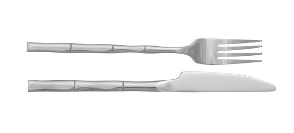 Photo of Knife and fork isolated on white, top view. Stylish shiny cutlery set