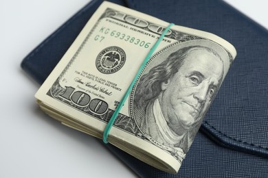 Photo of Money exchange. Dollar banknotes and wallet on white background, closeup