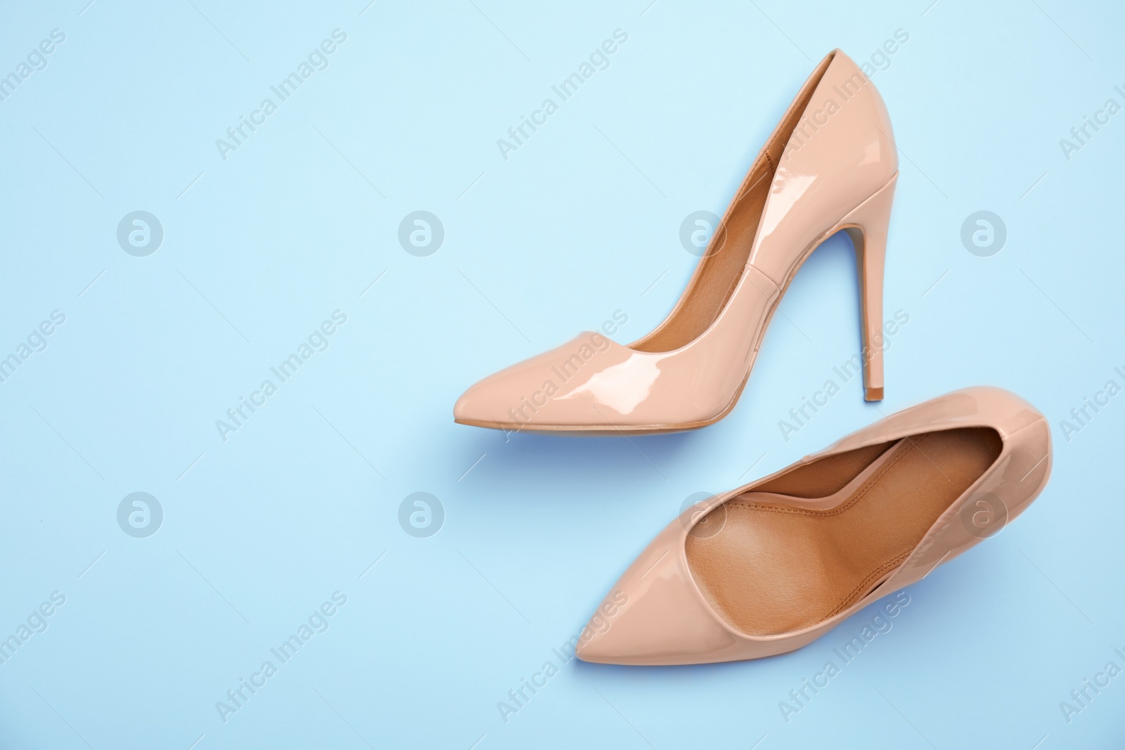 Photo of Pair of beautiful shoes and space for text on color background, top view