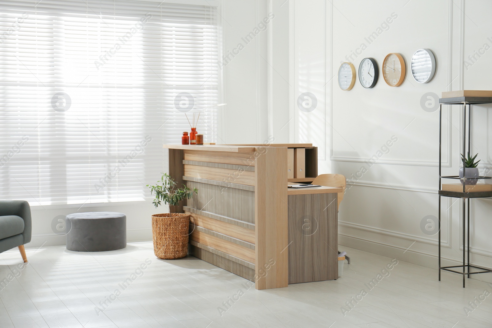 Photo of Hotel lobby interior with wooden reception desk. Stylish workplace