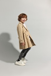 Fashion concept. Stylish boy posing on light grey background