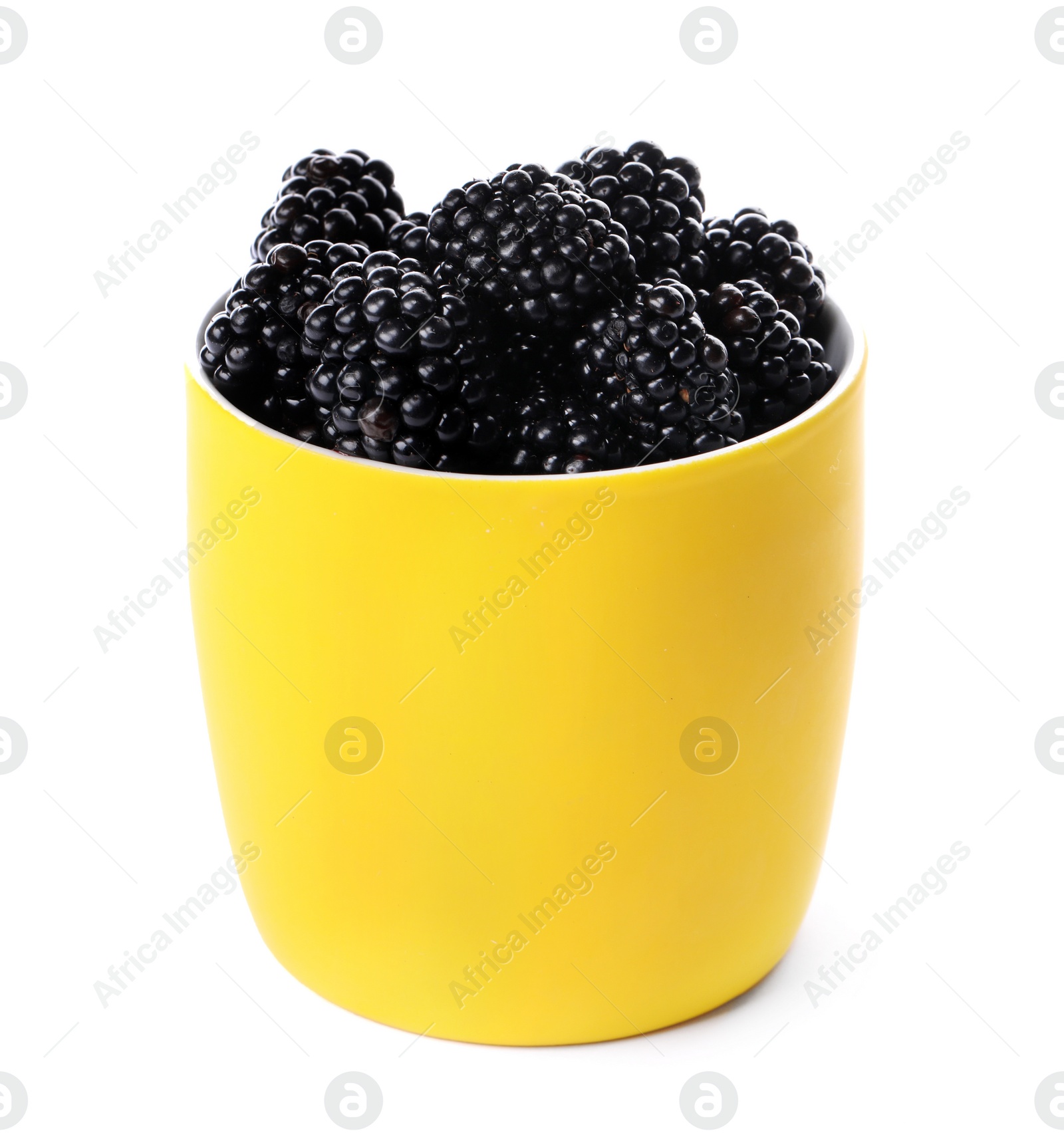 Photo of Yellow cup of tasty blackberries on white background