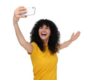 Beautiful young woman taking selfie on white background