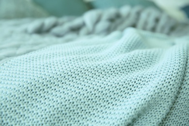 Photo of Texture of warm knitted mint blanket, closeup