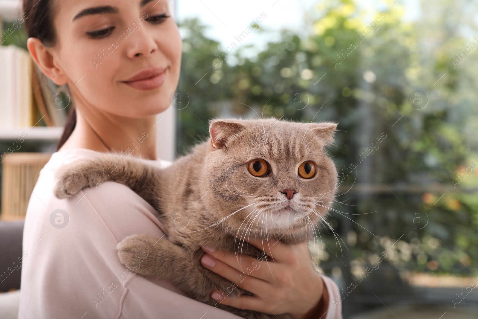 Photo of Woman with her adorable cat at home