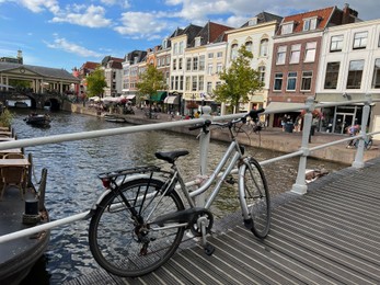 Photo of Beautiful view of bicycle on pedestrian bridge near canal in city