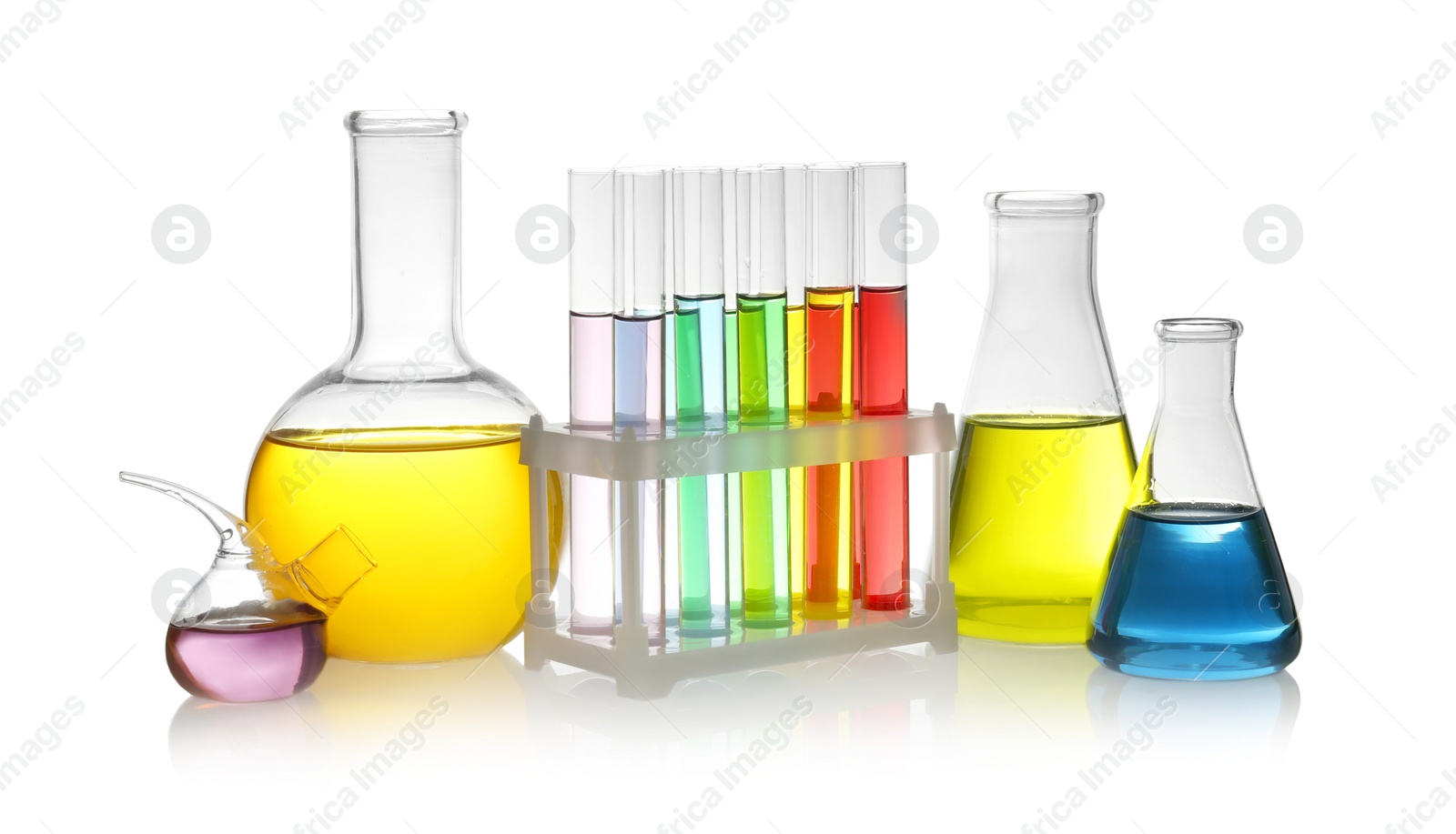 Photo of Laboratory glassware with colorful liquids on white background